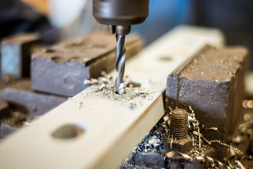 drilling in flat steel plate with bench drill.