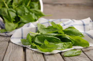 Fresh spinach leaves on rustic wooden background, selective focus, copy space