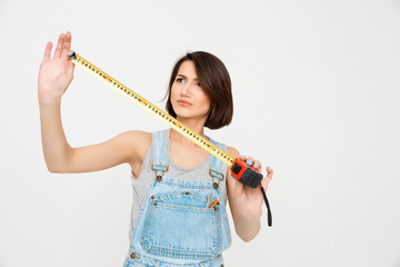 portrait of young beautiful girl , looking on the tape measure
