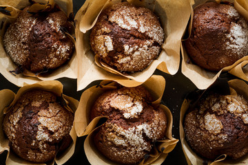 Chocolate banana muffins on dark wooden background. Selective focus