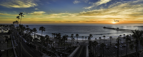 This is a colorful three image aerial sunset panoramic of Oceanside, California, USA. Oceanside is 40 miles North of San Diego, California.