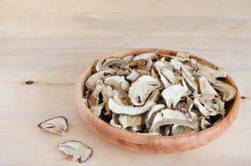 Dried porcini mushrooms on a wooden table. Autumn vegetables.
