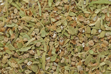 Organic dry True green cardamom (Elettaria cardamomum) big cut seeds. Macro close up background texture. Top view.