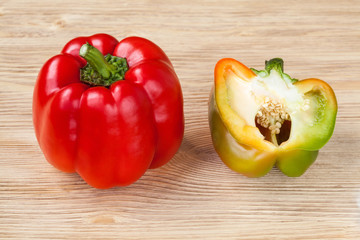 Red sweet bell peppers on a wooden background