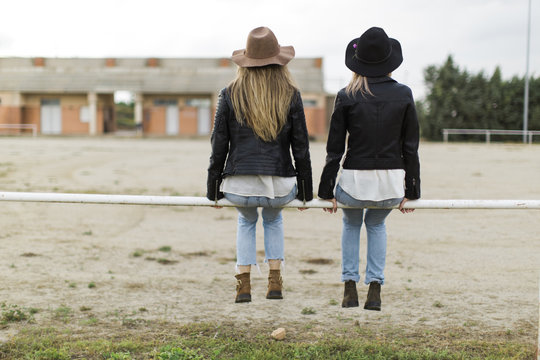 Two women sitting at soccer field