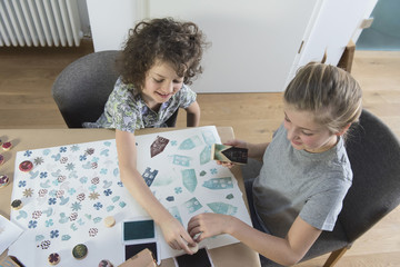 Two girls stamping on paper
