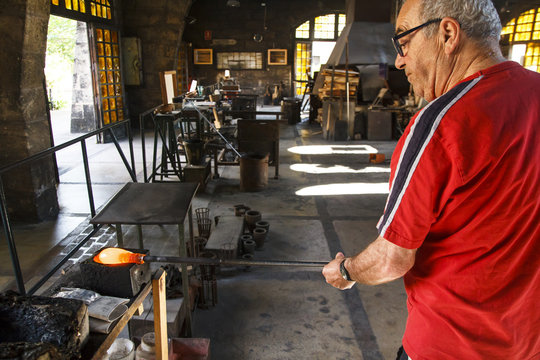 Man working with molten glass in a Factory in Mallorca