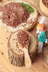 Flax seeds for health on wood background.