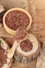 Flax seeds for health on wood background.