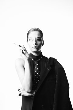 Portrait of stylish woman smoking a cigarette