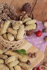 Peanut and boiled peanuts on wood background.