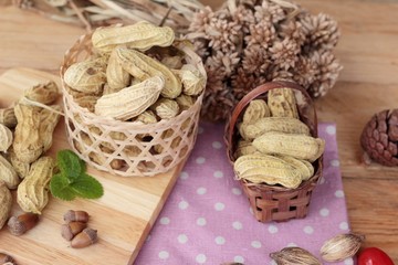 Peanut and boiled peanuts on wood background.