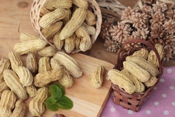 Peanut and boiled peanuts on wood background.
