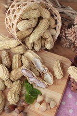 Peanut and boiled peanuts on wood background.