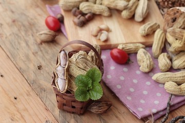 Peanut and boiled peanuts on wood background.