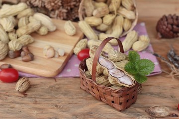 Peanut and boiled peanuts on wood background.
