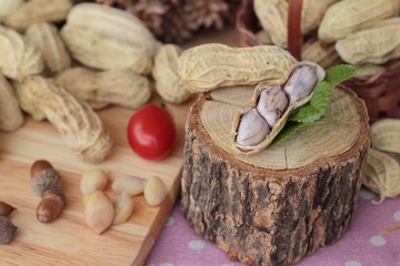 Peanut and boiled peanuts on wood background.