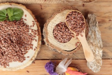 Flax seeds for health on wood background.