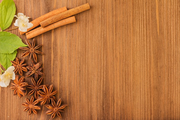 anise and cinnamon on a wooden board background