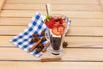 fruit cocktail blueberry banana strawberry on a wooden background