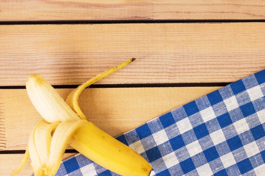 banana on a wooden background and a linen napkin