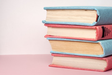 Stack of colorful books, grungy blue background, free copy space. Education essential for self improvement, gaining knowledge and success in our careers, business and personal lives.