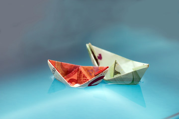 paper boats out of money in water