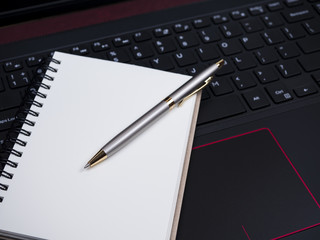 Blank notebook on laptop keyboard 5