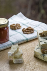 Several pieces of brie cheese with nuts and jam