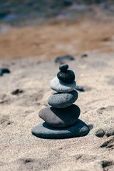 Fototapeta na wymiar Stones balance on vintage beach, inspirational summer landscape.