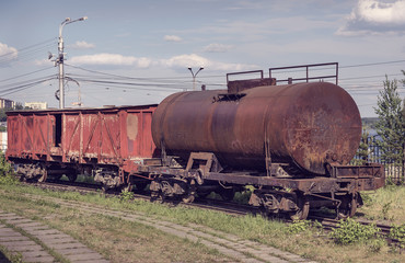 Fototapeta na wymiar Old covered goods wagon and tank car