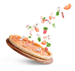 Vegetables fly to pizza on a white background