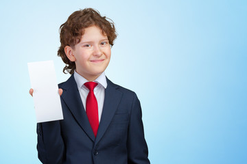 smiling boy holding blank paper