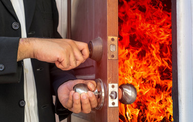 abstract business man will close the door for shut fire burn
