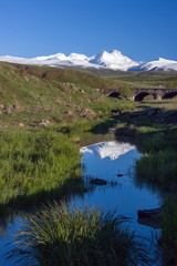 Snowcapped mount of Aragats with green hills in front