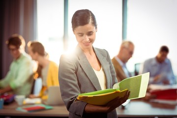 Businesswoman looking at the document 