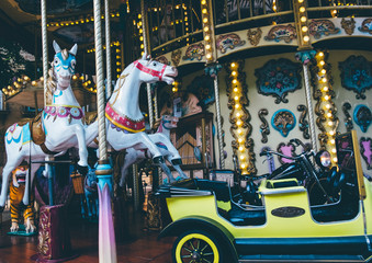 Fototapeta na wymiar Carousel with horses in amousement Luna Park