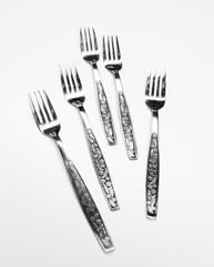 Old metal forks isolated on a white background.