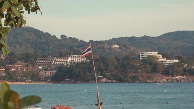 Thailand Flag On The Blue Sea, Sky and Mountains Background