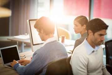 Man working on laptop with coworker