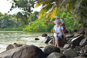 elderly couple rest at tropical beach