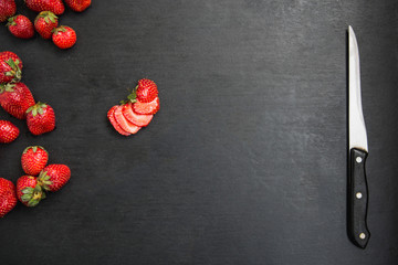 sliced strawberry on black table