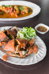Steamed blue crabs cut in half put on white dish. Selective Focu