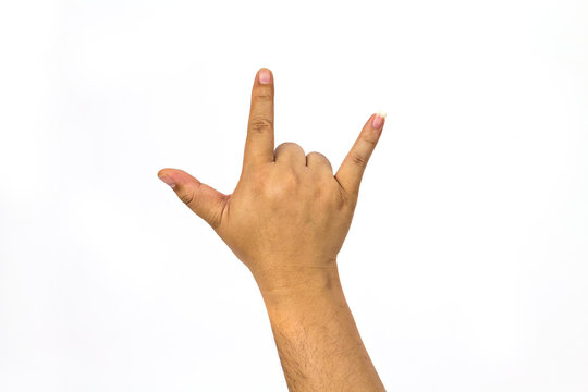 Hand shows the rock and roll sign or I love you sign isolated on a white background.