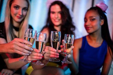 Group of smiling friend toasting glass of champagne