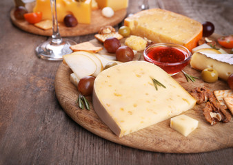 Different kinds of cheese on wooden background