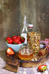 Healthy breakfast: granola with honey and strawberry.