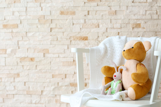 Baby toys on brick wall background