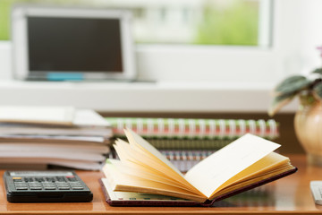 Office desk table with computer, supplies, flower. Copy space for text