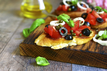 Bruschetta with tomato,black olives,capers and sauce pesto.